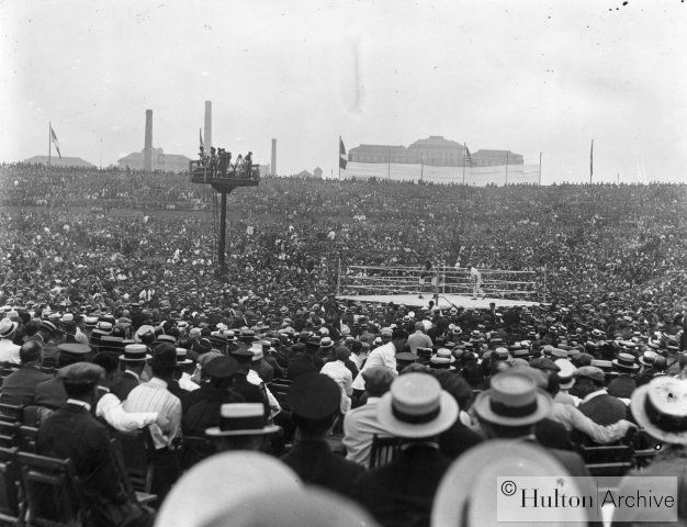 A large crowd watches heavyweight champion Jack Dempsey defend his title against challenger George Carpentier, July 2, 1921, in Jersey City, N.J. Demp.jpg